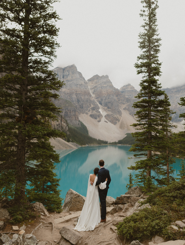 Couple standing at lake moraine in banff canada