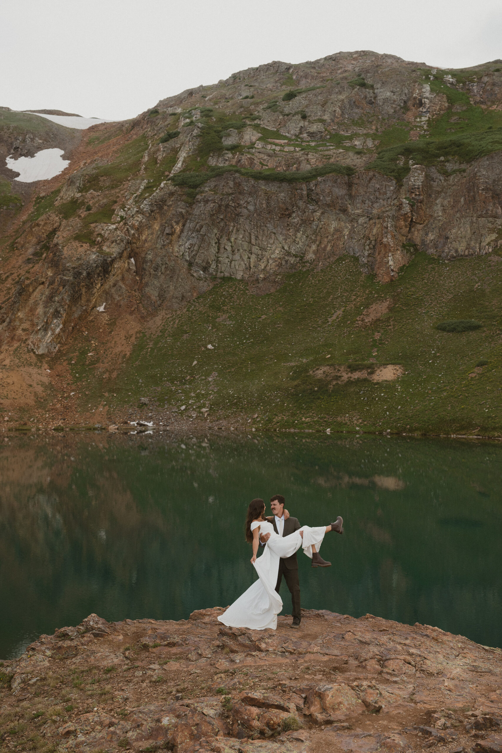 couple twirling by alpine lake in colorado