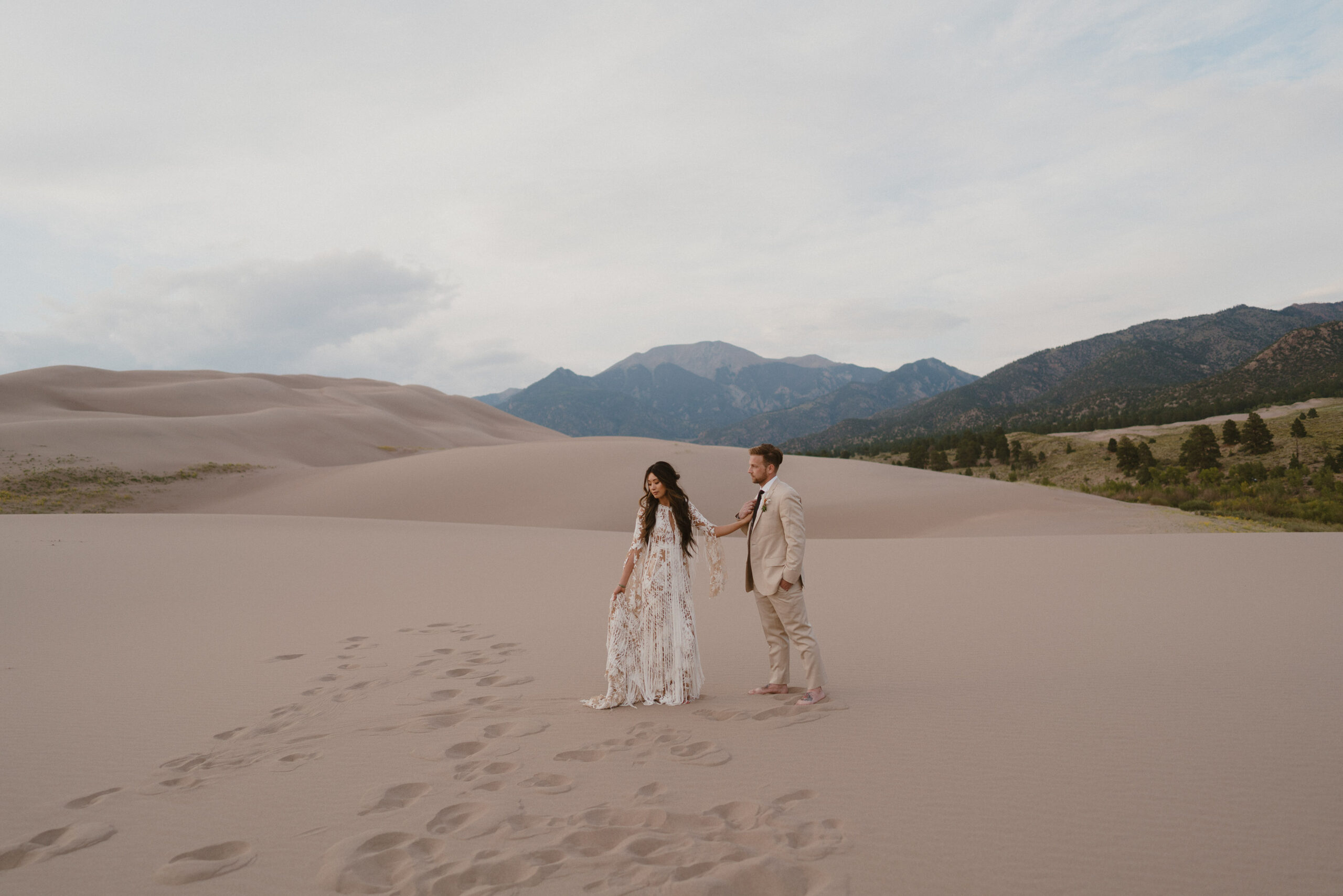 wedding couple on sand dunes in great sand dunes national park colorado
