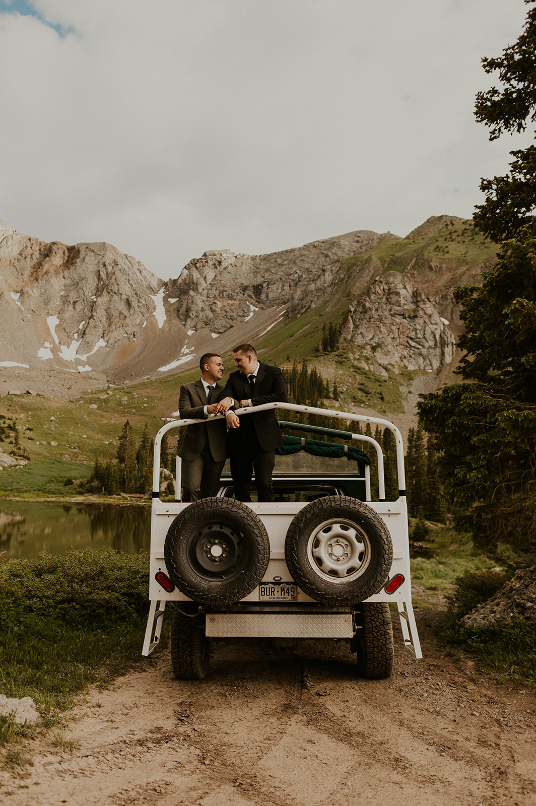 couple standing on jeep in telluride