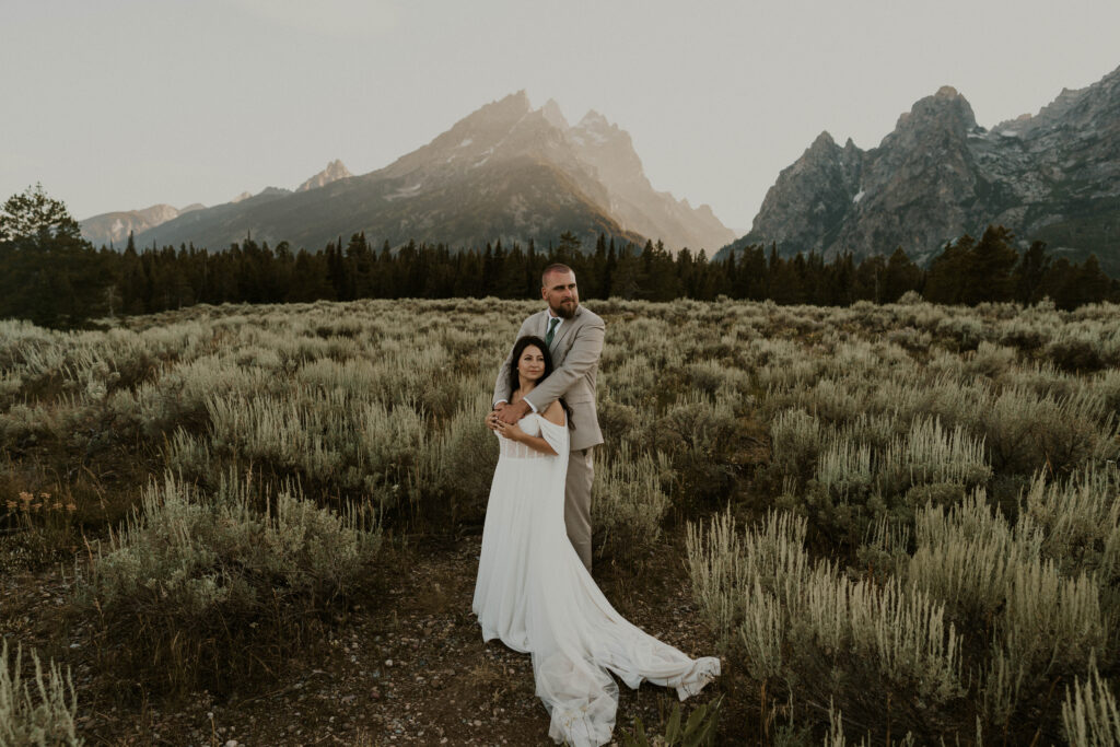 couple in field in grand teton national park
