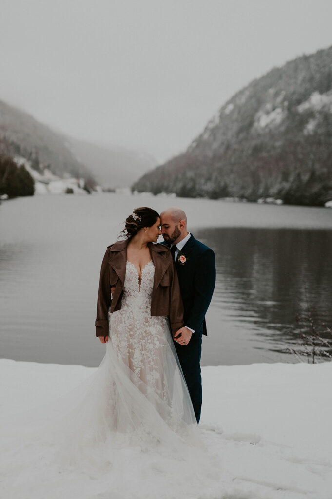 couple standing in snow in lake placid ny