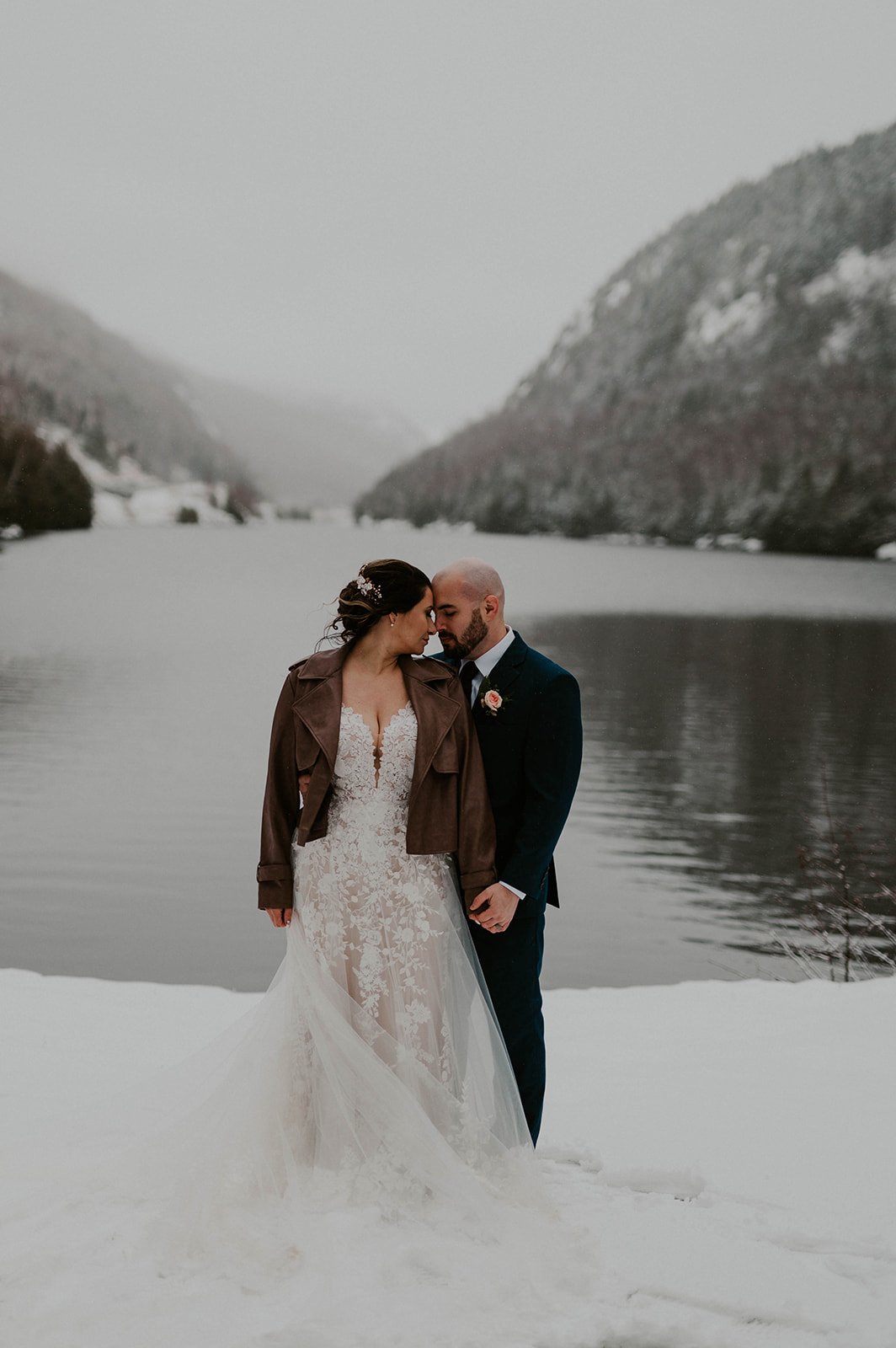 couple standing in snow in lake placid ny